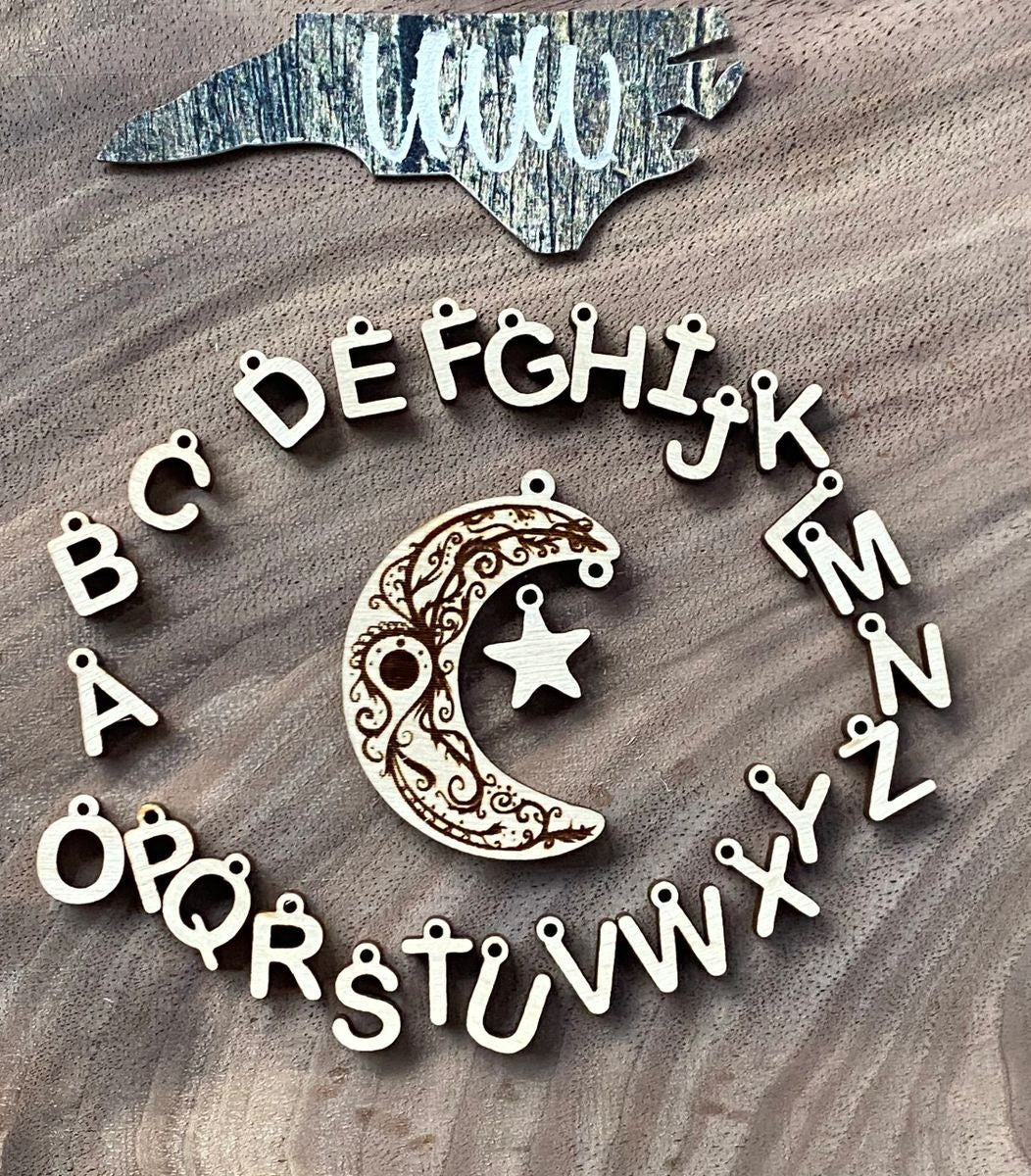 Engraved star dangle with star/letter charm